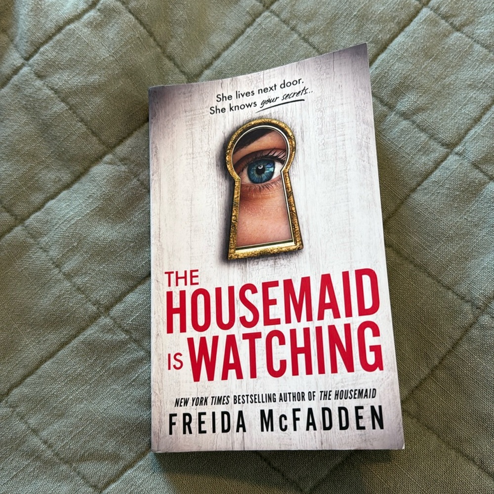 Housemaid is watching book by Frieda McFadden